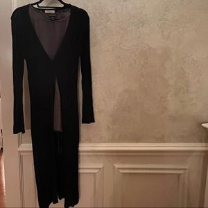 Long black acrylic duster with button and split hem